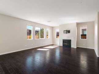 This spacious living room features a modern gas fireplace with a tile surround, perfect for cozy evenings.