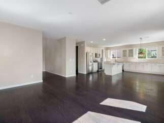 Experience modern living in this spacious open-concept home, featuring a gourmet kitchen with ample white cabinetry and a large island perfect for entertaining.