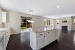 This spacious open-concept kitchen and living area features a large island with granite countertops, perfect for entertaining.