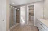Step into this luxurious bathroom featuring a spacious glass-enclosed shower with elegant tilework.
