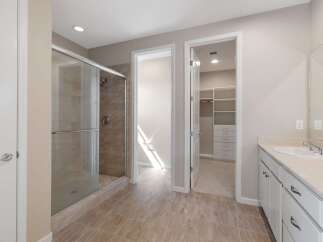 Step into this luxurious bathroom featuring a spacious glass-enclosed shower with elegant tilework.