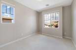 This bright and airy room features two large windows offering scenic views of the surrounding neighborhood and hills.
