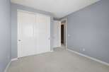 This bedroom features a spacious closet with double white doors, perfect for ample storage.