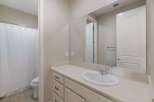 This bathroom features a spacious vanity with ample counter space and storage, perfect for organizing your essentials.