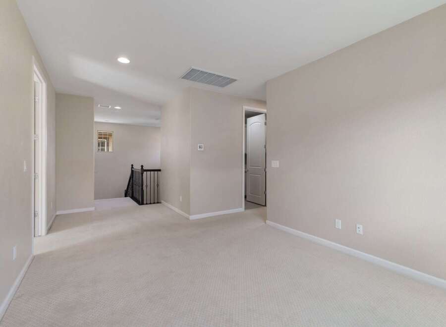 This spacious upstairs landing offers a bright and airy feel, perfect for a home office or additional living space.