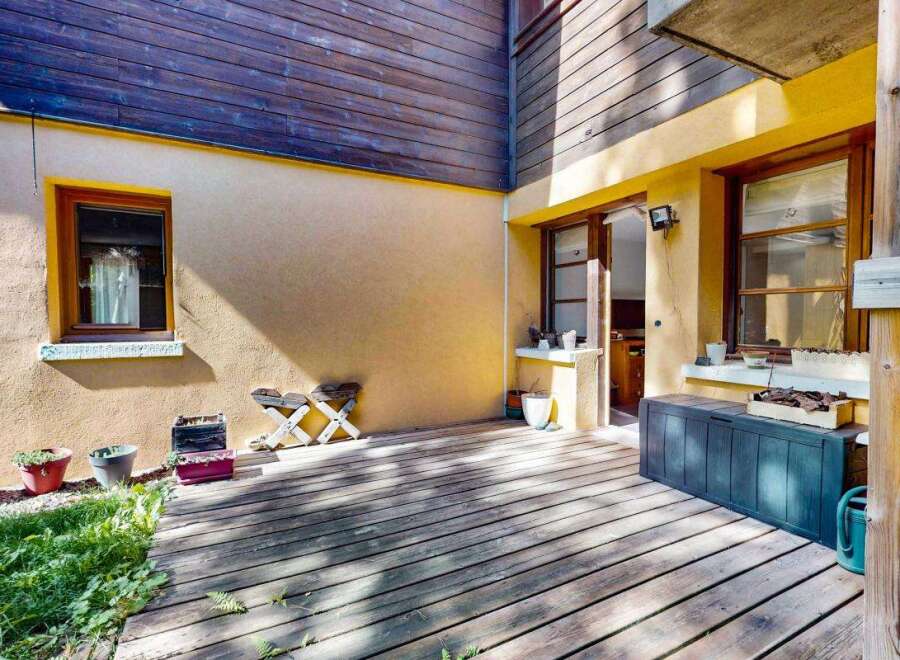 Enjoy outdoor living on this charming wooden deck, perfect for relaxing or entertaining.