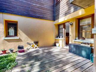 Enjoy outdoor living on this charming wooden deck, perfect for relaxing or entertaining.