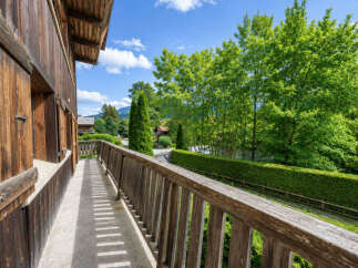 Enjoy the serene mountain views from this charming wooden balcony, perfect for morning coffee or evening relaxation.