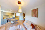 Experience modern living in this beautifully appointed apartment, featuring a sleek, integrated kitchen with ample cabinet space and a stylish dining area perfect for intimate meals.