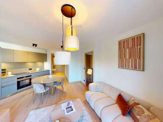 Experience modern living in this beautifully appointed apartment, featuring a sleek, integrated kitchen with ample cabinet space and a stylish dining area perfect for intimate meals.