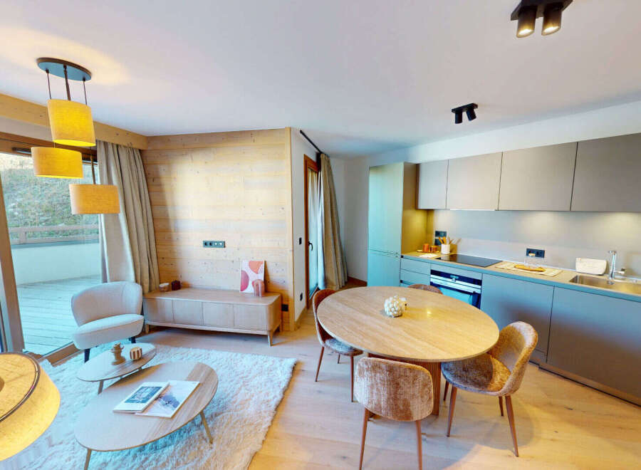 Experience modern alpine living in this beautifully appointed apartment, featuring a spacious open-plan living and dining area with a sleek, integrated kitchen.