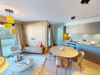 Experience modern alpine living in this beautifully appointed apartment, featuring a spacious open-plan living and dining area with a sleek, integrated kitchen.
