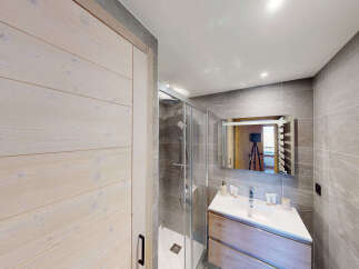 Experience modern comfort in this beautifully appointed bathroom, featuring a sleek shower enclosure and a stylish vanity with ample storage.