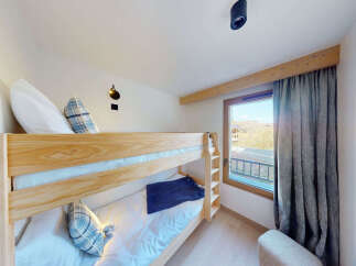 This charming bedroom features a sturdy wooden bunk bed, perfect for families or accommodating guests.