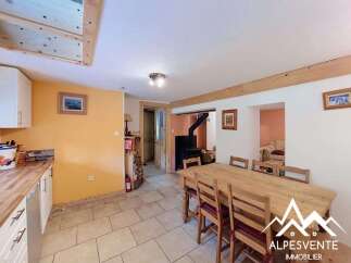 This charming dining area features a rustic wooden table with chairs, perfect for family meals.