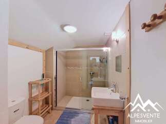 This bathroom features a spacious walk-in shower with tiled walls and a glass enclosure.
