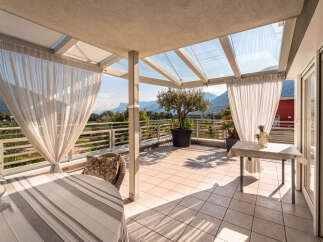 Enjoy breathtaking mountain views from this stunning covered patio, perfect for al fresco dining or relaxing with a book.