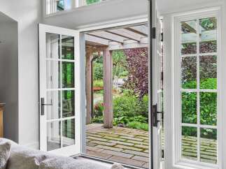 Step outside into a lush, private backyard oasis through elegant French doors.