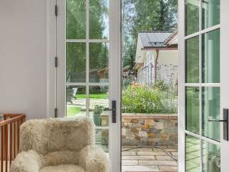 Step outside into a beautifully landscaped backyard through elegant French doors.