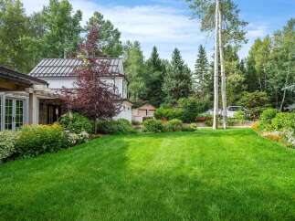 Experience the charm of this beautifully landscaped property, featuring a lush green lawn perfect for outdoor activities.