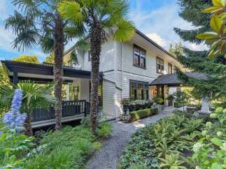 Discover this charming home featuring a welcoming covered porch and lush, mature landscaping.