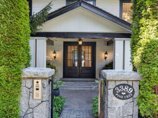 Welcome to this stunning residence featuring a classic facade with a welcoming covered entryway and elegant double doors.