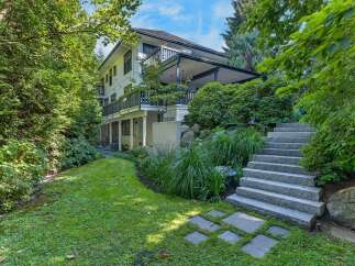 Discover this stunning multi-level home nestled amidst lush greenery, offering a private oasis.