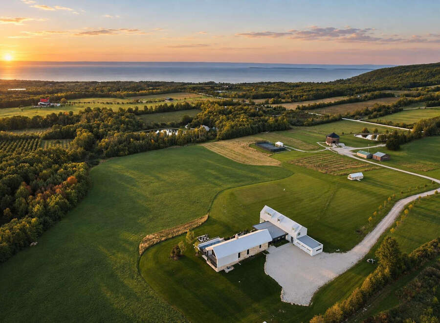 Experience luxury living in this stunning modern estate, perfectly situated to capture breathtaking sunset views over the water.