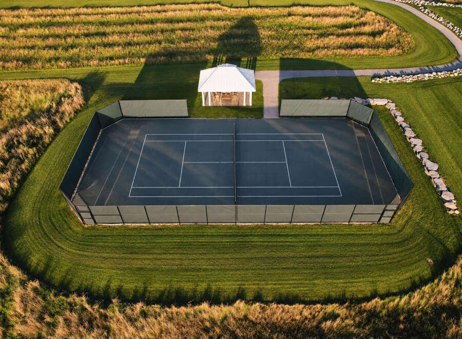 Experience luxury outdoor living with this stunning tennis court, perfectly integrated into a beautifully landscaped estate.