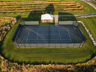 Experience luxury outdoor living with this stunning tennis court, perfectly integrated into a beautifully landscaped estate.