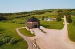 Discover this unique octagonal barn, a stunning architectural gem nestled in a serene rural landscape.