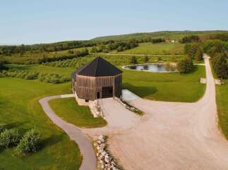 Discover this unique octagonal barn, a stunning architectural gem nestled in a serene rural landscape.