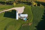 Experience modern luxury with this stunning aerial view of a contemporary home featuring a sleek design and expansive grounds.