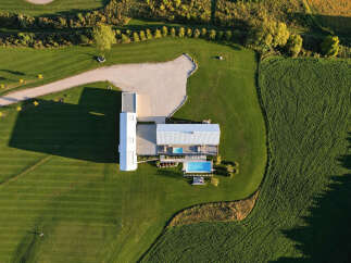 Experience modern luxury with this stunning aerial view of a contemporary home featuring a sleek design and expansive grounds.
