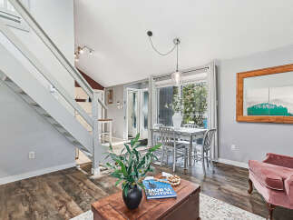 Discover this charming living and dining area featuring a modern metal dining set perfect for intimate meals.