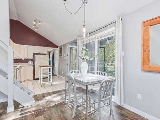 This charming dining area features a sleek, modern table with matching chairs, perfect for intimate meals.