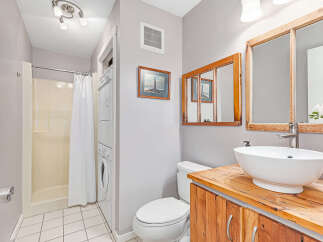 This bathroom features a convenient stacked washer and dryer unit, perfect for maximizing space.