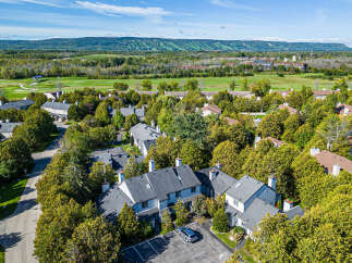 Discover this charming townhome community nestled amidst lush greenery and mature trees, offering a serene residential escape.