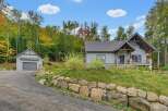 Discover this stunning mountain retreat featuring a modern A-frame home with stone accents and a detached garage.
