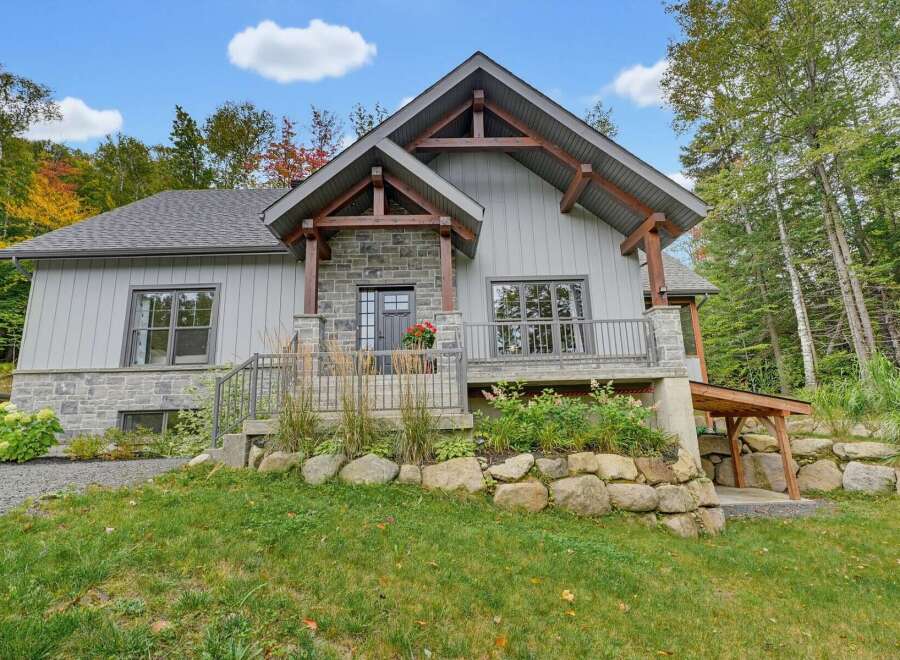 Discover this charming mountain home featuring a striking stone and wood exterior, perfect for a serene getaway.