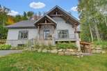 Discover this charming mountain home featuring a striking stone and wood exterior, perfect for a serene getaway.