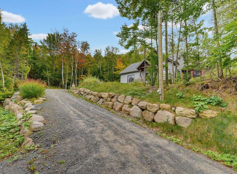Discover this charming property nestled amidst a vibrant autumn forest.