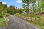 Discover this charming property nestled amidst a vibrant autumn forest.
