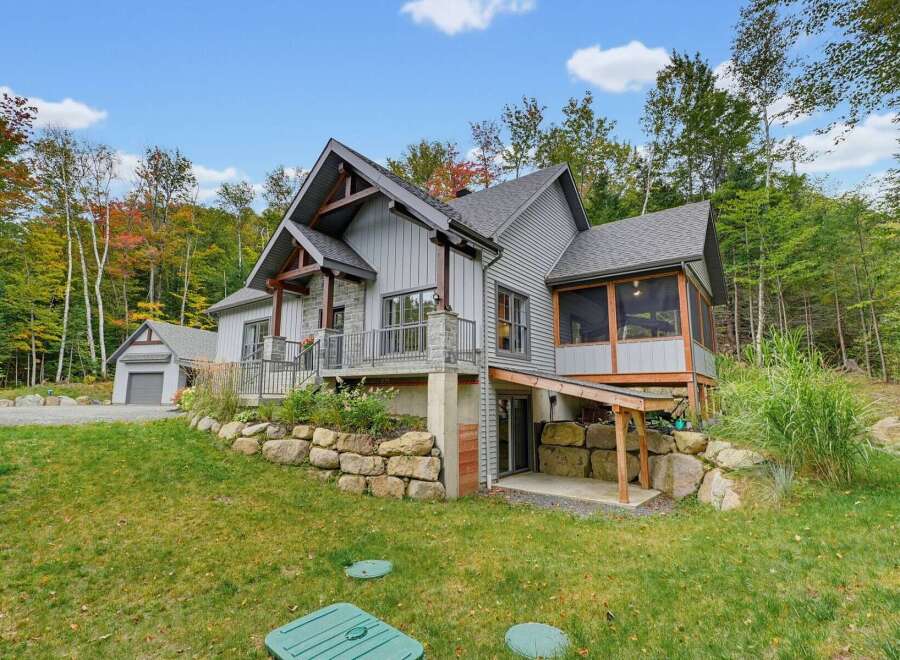 Discover this stunning modern home nestled amidst vibrant autumn foliage.