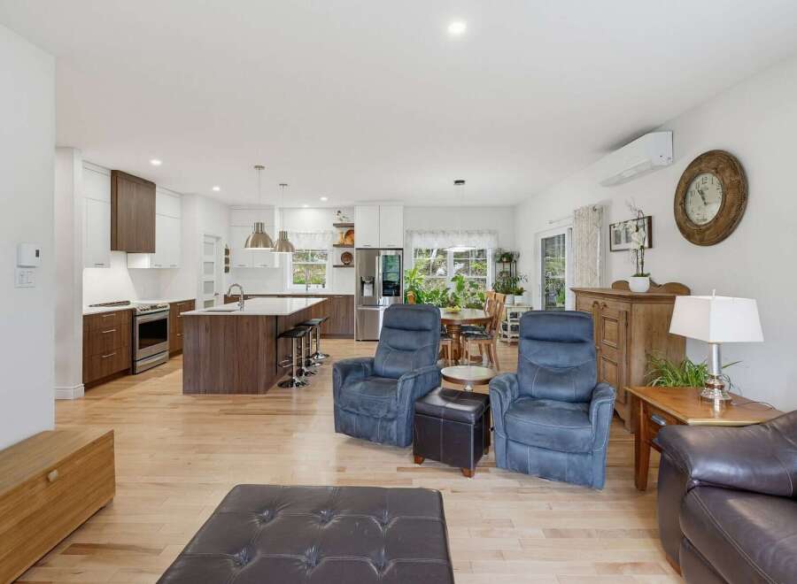 Experience modern living in this open-concept home featuring a gourmet kitchen with a large island and sleek cabinetry.