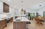 Experience modern living in this stunning kitchen featuring sleek white cabinetry contrasted with rich wood accents.