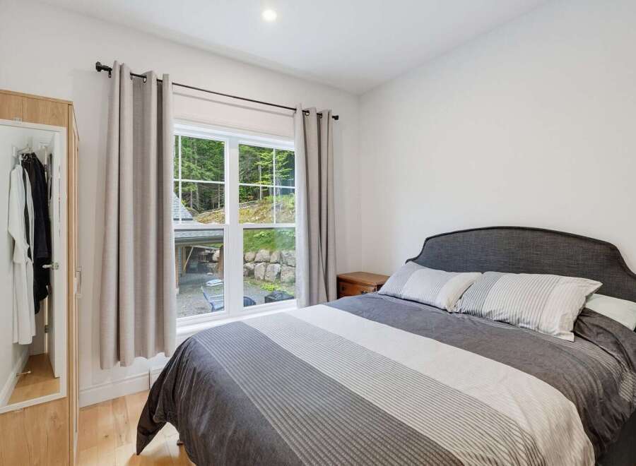 Discover comfort and style in this inviting bedroom, featuring a plush queen-size bed with a chic upholstered headboard.