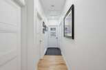 Step into this bright and airy hallway, featuring pristine white doors and elegant trim.