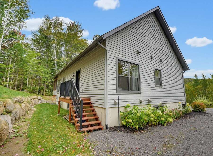 Discover this charming home nestled amidst lush greenery and mature trees, offering a serene retreat.