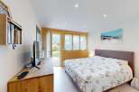 Experience cozy living in this charming bedroom featuring a comfortable bed with a nature-inspired duvet cover.